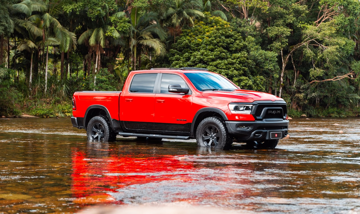 Red Ram Rebel driving through shallow water off-road